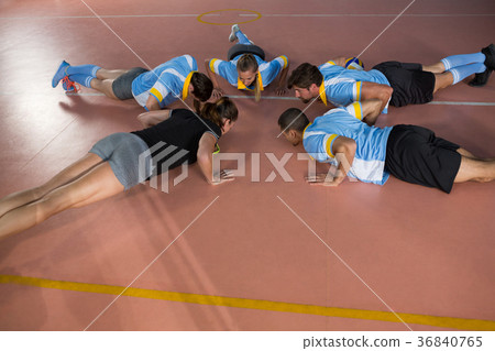 Volleyball team doing push-ups with coach Volleyball team doing push-ups with coach 36840765