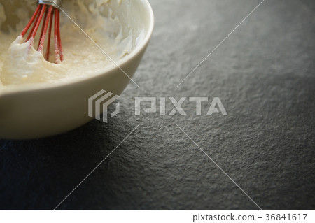 Overhead view of batter with wire whisk in bowl Overhead view of batter with wire whisk in bowl 36841617