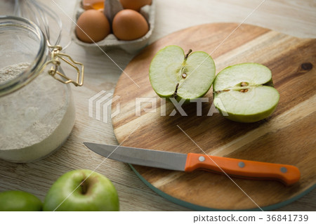 High angle view of granny smith apple halved on cutting board High angle view of granny smith apple halved on cutting board 36841739