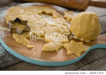 Close up of dough on cutting board with star shape cutter 36841754