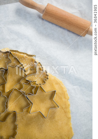 Close up of various shape pastry cutter on rolled dough 36841985