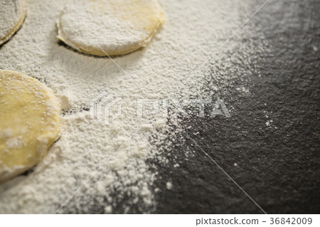 Cropped image of flour on unbaked cookies 36842009