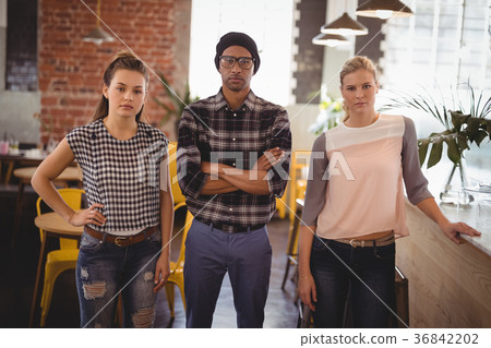 Confident young friends at coffee shop Confident young friends at coffee shop 36842202