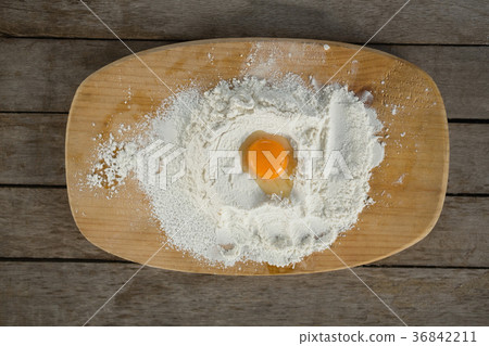 Directly above shot of egg yolk in flour on cutting board Directly above shot of egg yolk in flour on cutting board 36842211