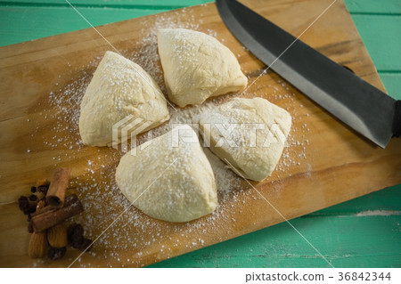 High angle view of raw cookies by knife on cutting board High angle view of raw cookies by knife on cutting board 36842344