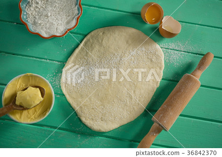 Overhead view of rolled dough by rolling pin and ingredients 36842370
