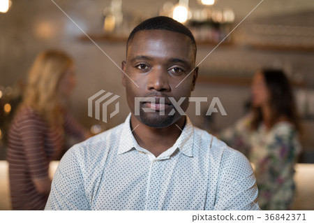 Man standing in restaurant Man standing in restaurant 36842371