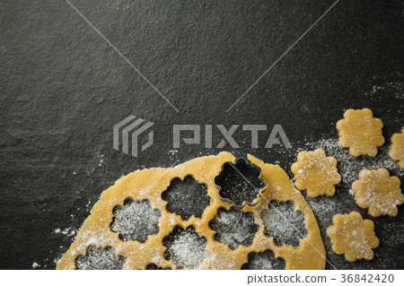 Overhead view of flower shape mould on dough Overhead view of flower shape mould on dough 36842420