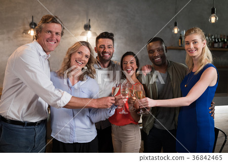 Portrait of happy friends toasting champagne Portrait of happy friends toasting champagne 36842465