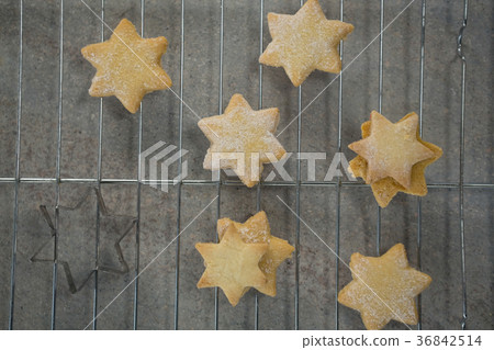 Overhead view of star shape cookies on cooling rack 36842514