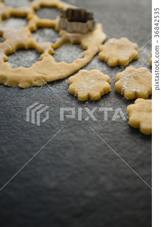 Close up of flower shape pastry cutter on dough Close up of flower shape pastry cutter on dough 36842535