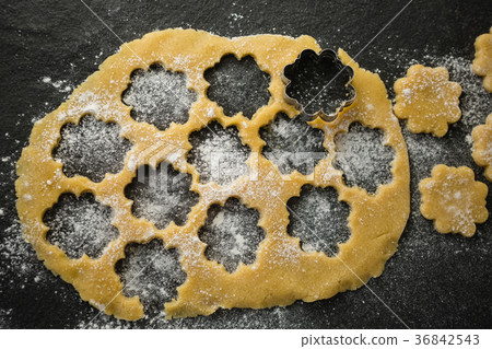 Close up of flower shape mould on dough Close up of flower shape mould on dough 36842543