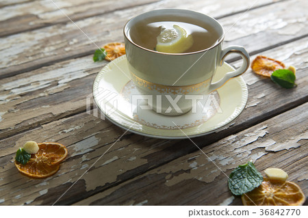 High angle view of lemon and mint leaves in ginger tea on weathered table 36842770