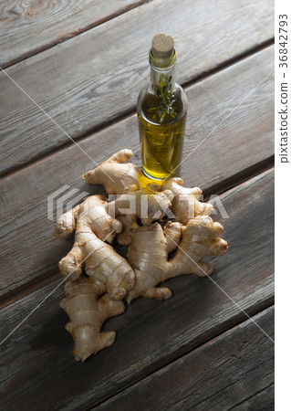 High angle view of gingers by oil bottle on table High angle view of gingers by oil bottle on table 36842793