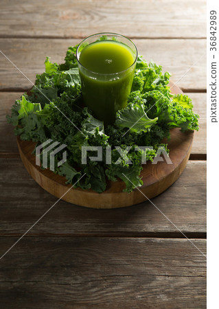 Fresh kale juice in glass on table Fresh kale juice in glass on table 36842989