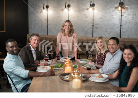 Happy friends dining in restaurant 36842990