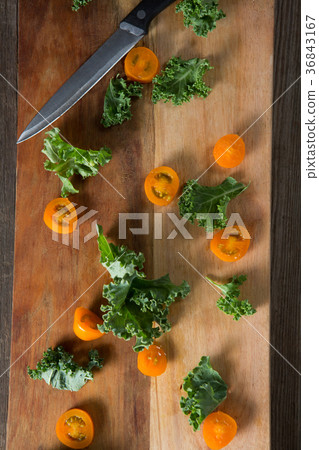 Kale with tomato slices on cutting board Kale with tomato slices on cutting board 36843167