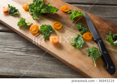 High angle view of kale and tomato slices on cutting board 36843219