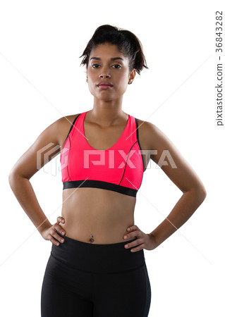 Confident female athlete against white background Confident female athlete against white background 36843282