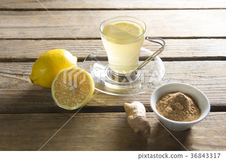 Tea cup with lemon and ginger on wooden table Tea cup with lemon and ginger on wooden table 36843317