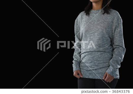 Mid section of woman against black background 36843376