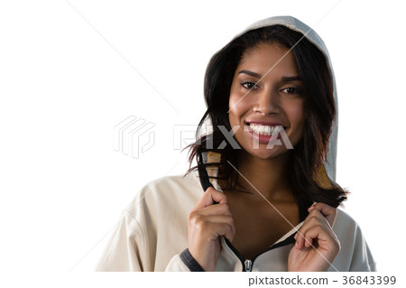 Smiling female athlete wearing hooded jacket Smiling female athlete wearing hooded jacket 36843399