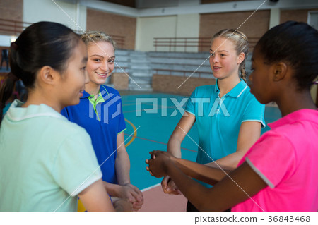 Volleyball players with their hands stacked Volleyball players with their hands stacked 36843468