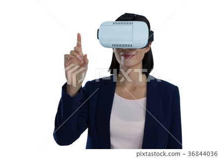 Businesswoman gesturing while using virtual reality headset Businesswoman gesturing while using virtual reality headset 36844036