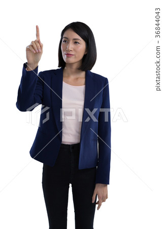 Businesswoman touching invisible screen Businesswoman touching invisible screen 36844043