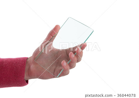 Close-up of man holding glass mobile phone Close-up of man holding glass mobile phone 36844078