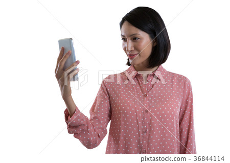 Female executive taking selfie with mobile phone Female executive taking selfie with mobile phone 36844114