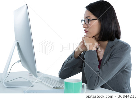 Businesswoman working on desktop pc 36844213