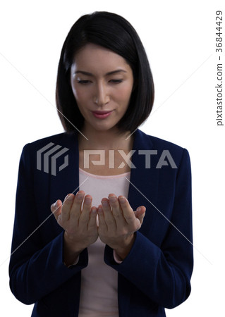 Businesswoman pretending to hold invisible object Businesswoman pretending to hold invisible object 36844429