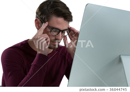 Stressed man sitting at desk Stressed man sitting at desk 36844745