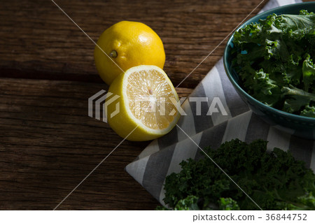 Mustard greens and lemon on wooden table 36844752