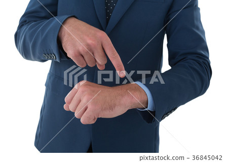 Mid section of businessman pointing on invisible wrist watch 36845042