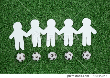 Paper cut outs and footballs arranged on artificial grass Paper cut outs and footballs arranged on artificial grass 36845043