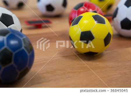 Various footballs on wooden table Various footballs on wooden table 36845045