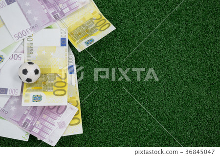 Footballs and currency notes on artificial grass Footballs and currency notes on artificial grass 36845047