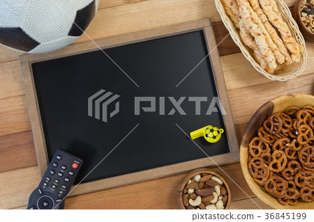 Snacks, football, whistle and slate on wooden table Snacks, football, whistle and slate on wooden table 36845199