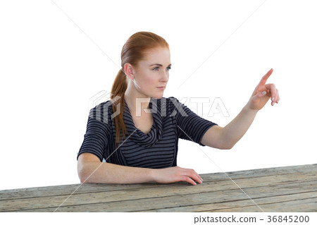 Confident businesswoman using imaginary screen Confident businesswoman using imaginary screen 36845200