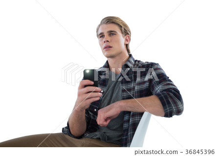 Businessman photographing while sitting on chair Businessman photographing while sitting on chair 36845396