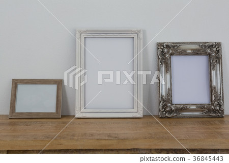 Frames arranged on wooden table Frames arranged on wooden table 36845443