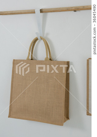 Bag hanging on wooden rod 36845490