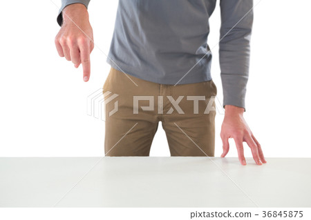 Mid section of creative businessman gesturing while standing at table Mid section of creative businessman gesturing while standing at table 36845875