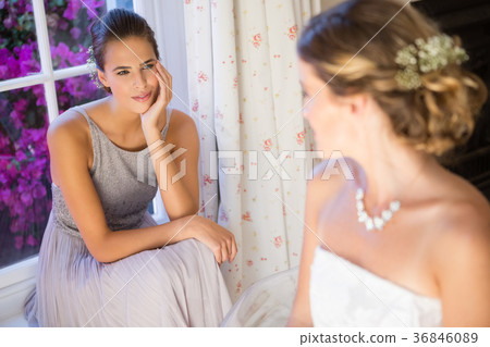 Bride talking to bridesmaid at home 36846089