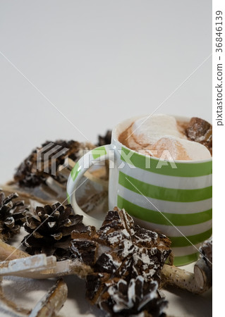 Chocolate drink and pines cones against white background Chocolate drink and pines cones against white background 36846139