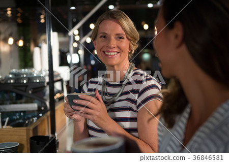 Happy woman interacting while having coffee 36846581