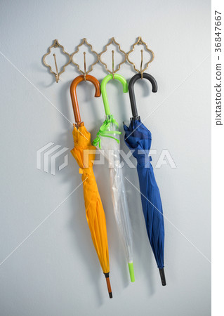 Colorful umbrellas hanging on hook 36847667