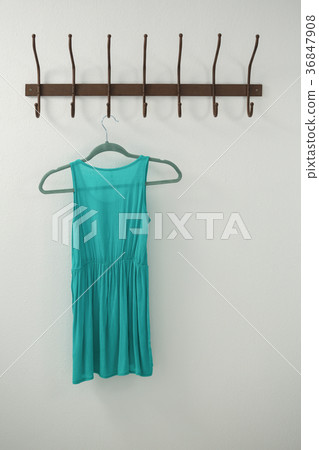 Turquoise dress hanging on hook 36847908